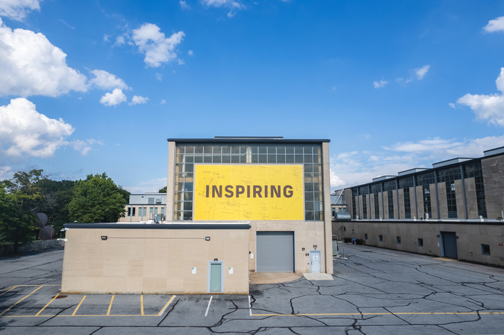 "Inspiring" Sign on Exterior of High Bay