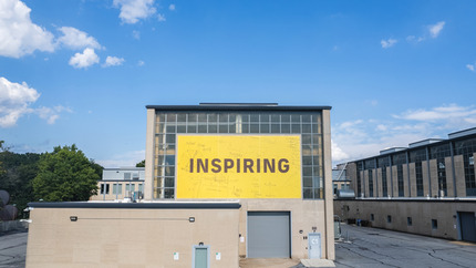 &quot;Inspiring&quot; Sign on Exterior of High Bay